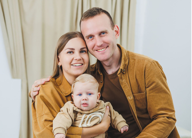 Family pictures with a newborn highlighting coordinated color outfits and simple styling