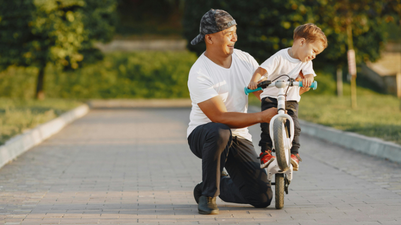 ai prompt father and son riding bikes'