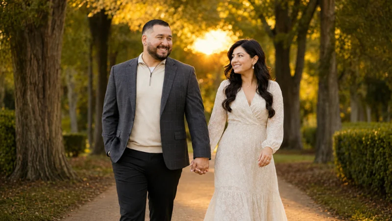 couple walking hand in hand at sunset
