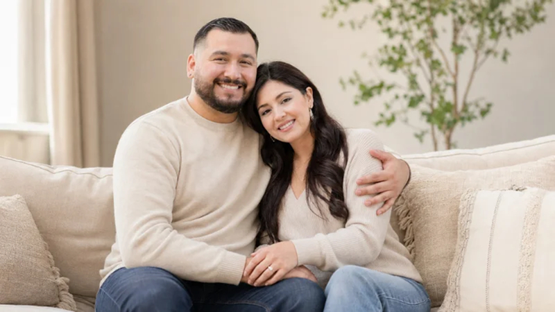 couple cuddling comfortably on a living room couch