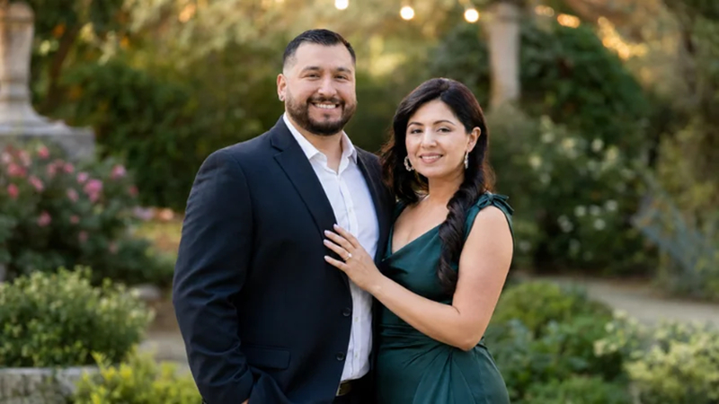 couple showing engagement ring in soft evening light