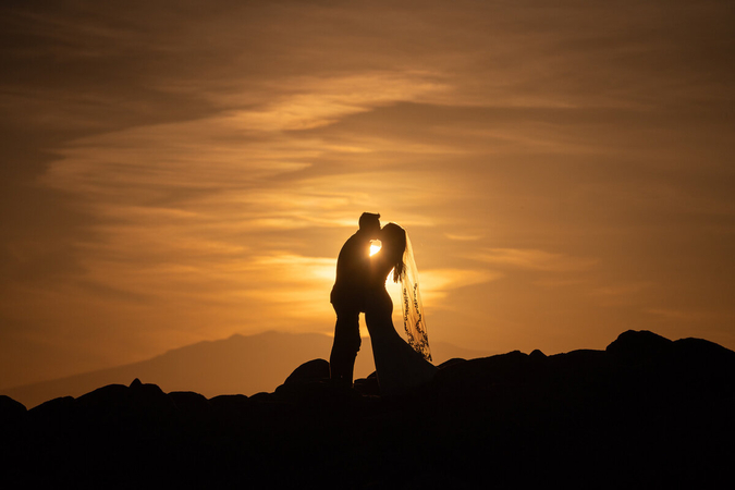 sunset silhouette elopement photography on an open horizon