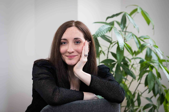 A girl with Arm on the Back of the Chair