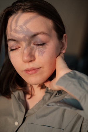 a girl with hand on her neck