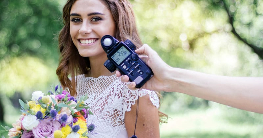 a girl is under shooting with a light meter