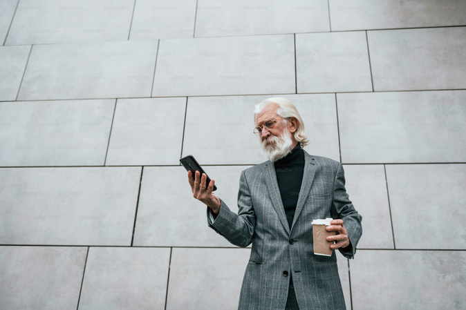 businessman watching his phone screen