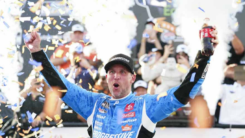 Denny Hamlin enjoys his win in Victory Lane after winning a NASCAR Cup Series auto race at Dover Motor Speedway, Sunday, July 20, 2025, in Dover, Delaware.