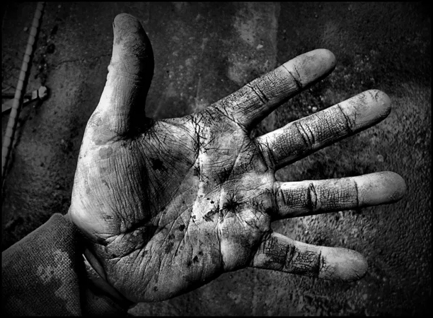 A hardworking hand showing strength, resilience, and dedication in black and white.