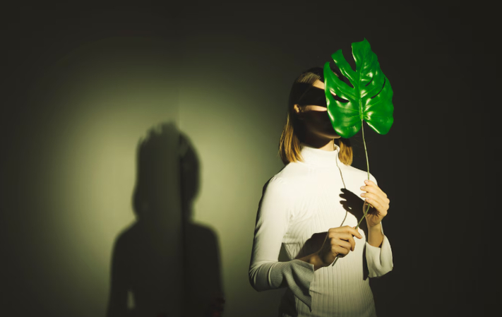 portrait photography of a girl with her shadow and plain background