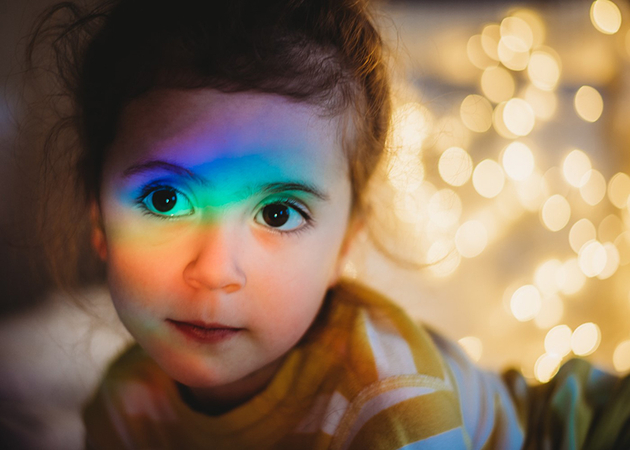 A portrait photo with digital rainbow colors overlaid diagonally.
