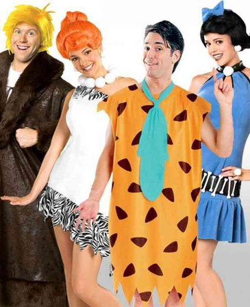 Four friends wearing leopard print and blue tunic Flintstones costumes at a party