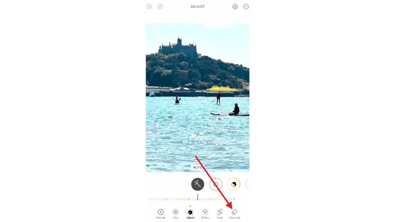 selecting clean up and brushing over a reflection in apple photos