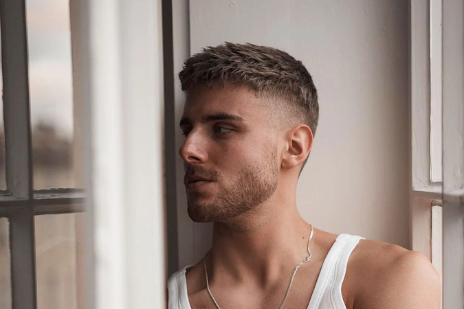boy standing with crew cut hairstyle