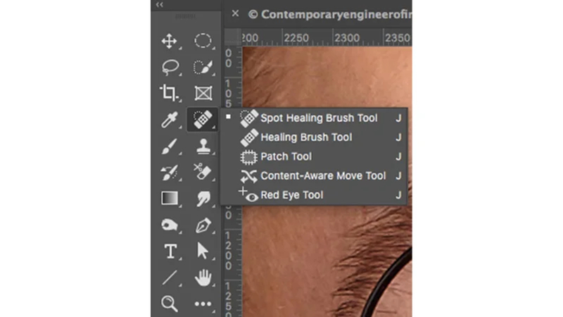 selecting the spot healing brush from the photoshop toolbar