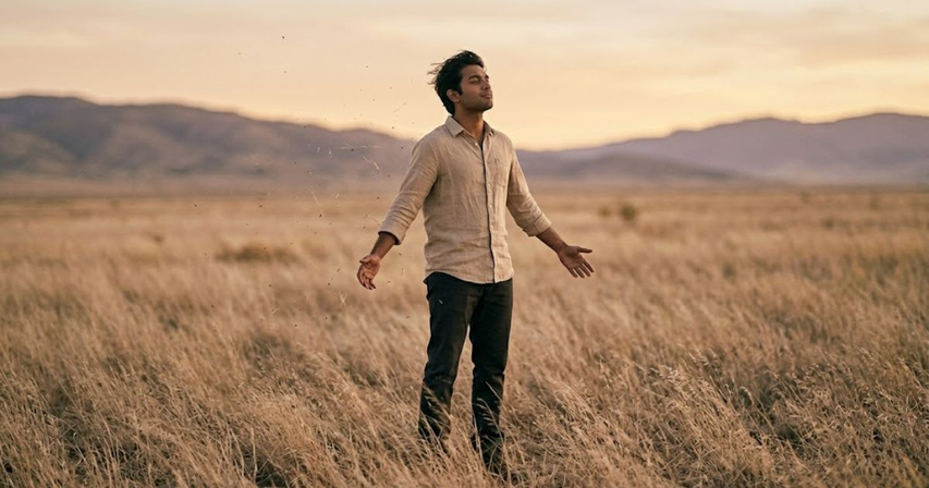 windy field open posture aura farming wide shot