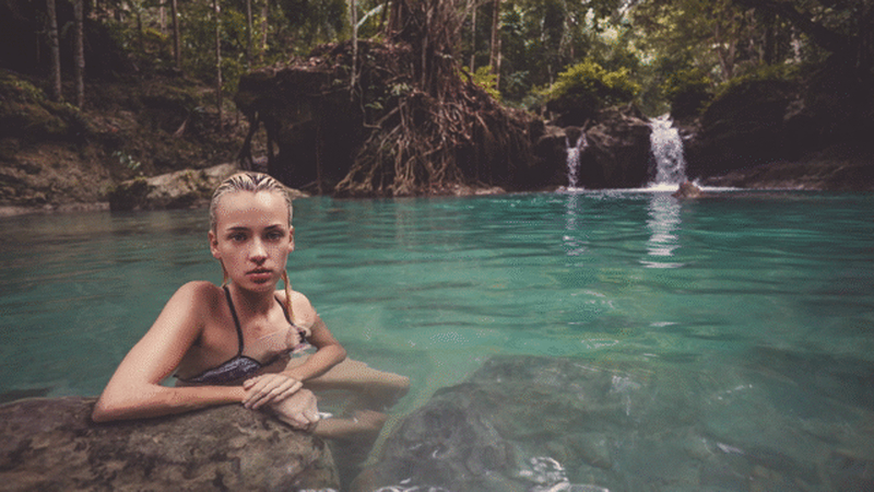 still photo of a girl water flowing in background
