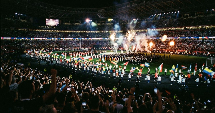 blurry and grainy stadium photo from a football opening ceremony