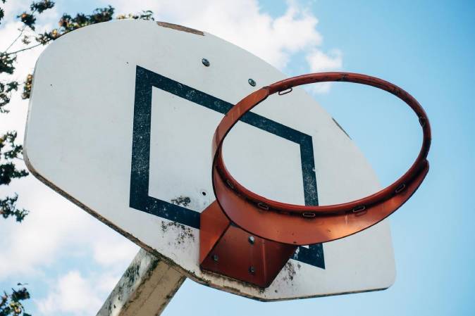 TBT basketball hoop and backboard under arena lights