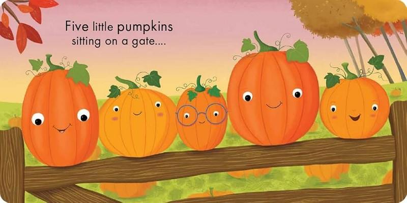 five little pumpkins sitting on a gate